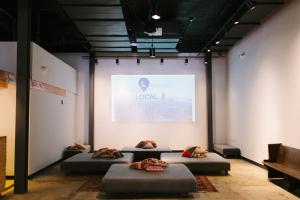 a room with four beds in front of a wall at The Local NY Hostel in Queens
