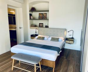 a bedroom with a large bed and a chair at Via Castello, Lake Como, Brienno in Brienno