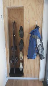 a room with skis and helmets on a wall at Ridge View in Wanaka