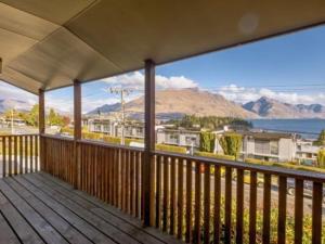 a wooden deck with a view of the mountains at ULTIMATE CONVENIENCE, WALK-TO-TOWN TOWNHOUSE in Queenstown