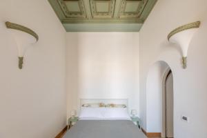 a bedroom with a bed with white walls and a ceiling at iFlat Monti Penthouse Panoramic View in Rome