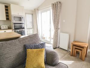 a living room with a couch and a window at Daisy Lodge in Scarborough