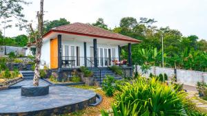 a small house in the middle of a garden at House of Belasun in Pelabuhan Ratu