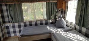 a bed sitting in a room with a window at 4U Pokój w domku holenderskim Rooms in Tinyhouse in Zgorzelec