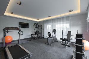 a gym with several treadmills and exercise bikes at Favorit Serviced Apartments in Ludwigsburg