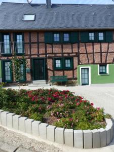 a building with a flower bed in front of it at Anduns exklusive Scheune in Boppard