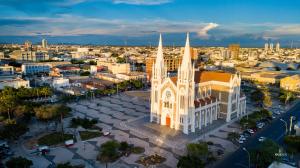 a large white church with a city in the background at Reis Palace Hotel in Petrolina