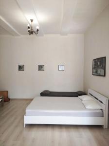 a white bedroom with a large white bed in it at Апартаменты на Героев-Чернобыльцев 27 in Poltava