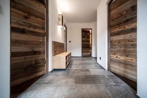 a hallway with wooden walls and a wooden door at Familienalm Taser in Schenna