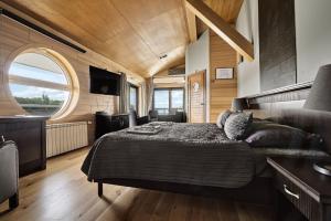 a bedroom with a bed and a large window at Vogue Boat Apartments in Budapest
