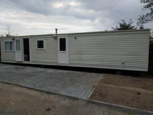 a white train car sitting on a track at 4U Pokój w domku holenderskim Rooms in Tinyhouse in Zgorzelec