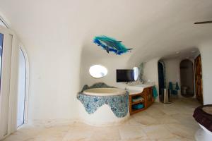 a bathroom with a fish sculpture on the wall at Swan Villas in Maya Beach