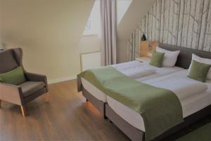 Postel nebo postele na pokoji v ubytování Hotel Eifelbräu