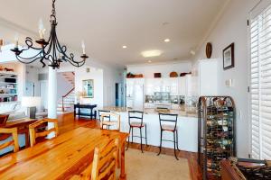 棕櫚島的住宿－Ocean Boulevard 802，厨房以及带木桌和椅子的用餐室。