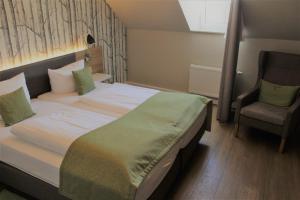 Postel nebo postele na pokoji v ubytování Hotel Eifelbräu