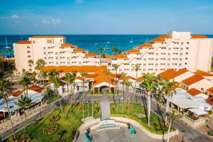 an aerial view of a resort with a fountain and the ocean at Playa Linda Beach Resort in Palm-Eagle Beach