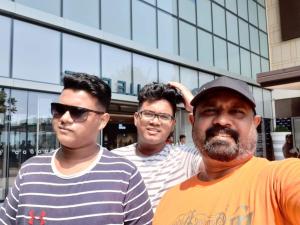 a group of three men standing in front of a building at Haputale Super View in Haputale