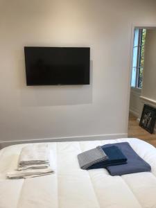 a room with a bed with a tv on the wall at Écrin Haut de Gamme possibilité jacuzzi Hamam in Clermont-Ferrand