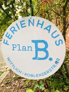 znak, który czyta truskawkowy plan b wiszący na drzewie w obiekcie Ferienhaus Plan B. Wittlich w mieście Wittlich