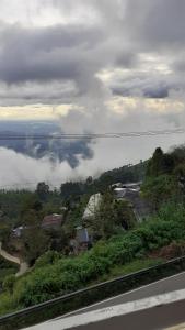 a view of a town on a hill with clouds in the sky at Haputale Super View in Haputale