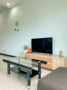 a living room with a flat screen tv on a entertainment center at Maison life 小居屋 The Loft Imago in Kota Kinabalu