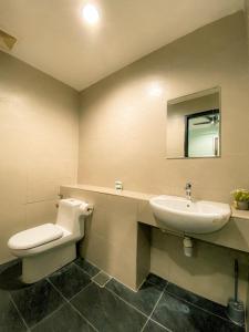 a bathroom with a toilet and a sink at Maison life 小居屋 The Loft Imago in Kota Kinabalu