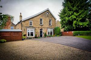 a large brick house with a driveway at West End Guest House in Richmond