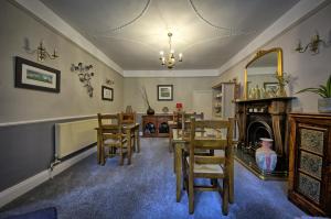 a dining room with a table and chairs and a fireplace at West End Guest House in Richmond +25 photos