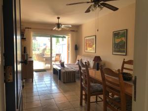 a living room with a table and a couch at Limnaria Villas - comfy 2 bed, 2 bath ground floor apartment in Paphos