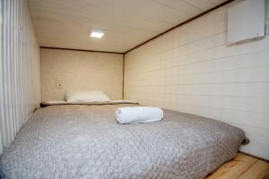 a small bedroom with a bed in it at KUBU Loft in Klaipėda