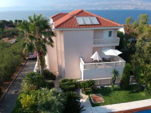 an aerial view of a house with the ocean in the background at Villa Keti apartments Pool & Wellness in Splitska