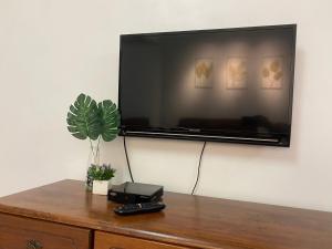 a flat screen tv hanging on a wall at Cameron Highland Cozy Homestay in Tanah Rata