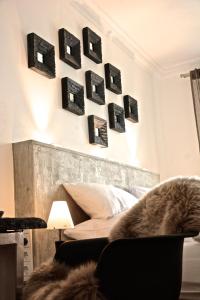 a bedroom with black pictures hanging on the wall at VILLA ADELEes BOUTIQUE HOTEL in Alsfeld