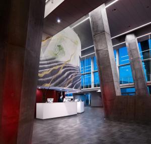 a man standing at a desk in an office lobby at Crowne Plaza Copenhagen Towers, an IHG Hotel in Copenhagen