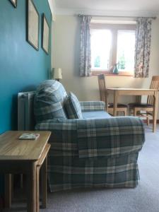 a living room with a couch and a table at Carents House in Montacute