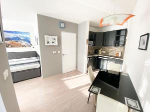 a kitchen and dining room with a table and chairs at Miky Apartmán Klínovec in Loučná pod Klínovcem
