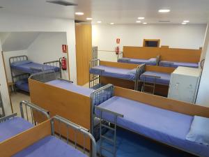 a row of bunk beds in a room at Albergue Albas exclusivo Peregrinos in Logroño
