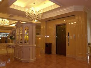 a large lobby with a chandelier and a building at Hotel Fine Garden Matsuyama in Matsuyama
