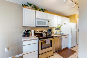 a kitchen with white cabinets and a stove top oven at Scandinavian Lodge in Steamboat Springs