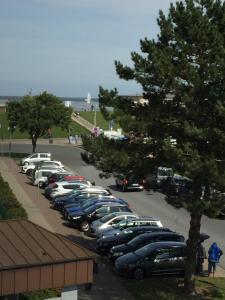 a bunch of cars parked in a parking lot at Seedeich Apartment in Cuxhaven