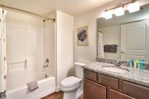 a bathroom with a toilet and a sink and a shower at 5I Cozy Family Friendly Moab Condo in Moab
