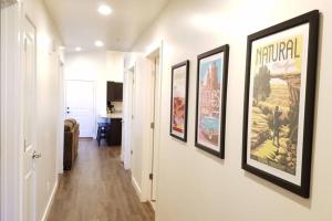 a hallway with three framed pictures on the wall at 5I Cozy Family Friendly Moab Condo in Moab