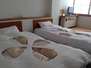 Postel nebo postele na pokoji v ubytování Resort Inn Chitose