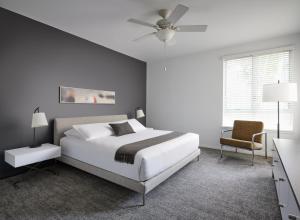 a bedroom with a bed and a ceiling fan at AKA Beverly Hills in Los Angeles