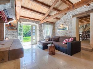 a living room with a couch and a stone wall at Holiday Home Hrelja - ROJ418 by Interhome in Žminj