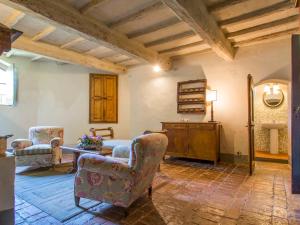 a living room with two chairs and a table at Holiday Home Casa delle Fiabe by Interhome in San Casciano in Val di Pesa +33 photos