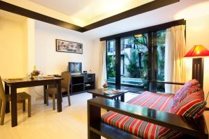 a living room with a couch and a table at S'cape Condotel in Sanur