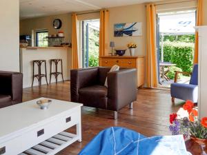 a living room with two chairs and a table at Holiday Home Stavoren by Interhome in Stavoren