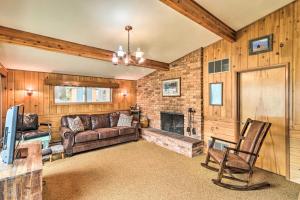 a living room with a couch and a fireplace at Flathead Lake Waterfront Cabin with Dock and Kayaks in Polson