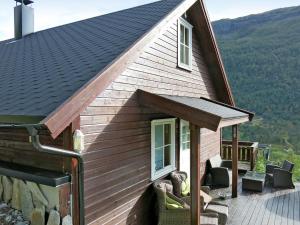a cabin with a porch and a roof at Holiday Home Peer Gynt by Interhome in Sogndal